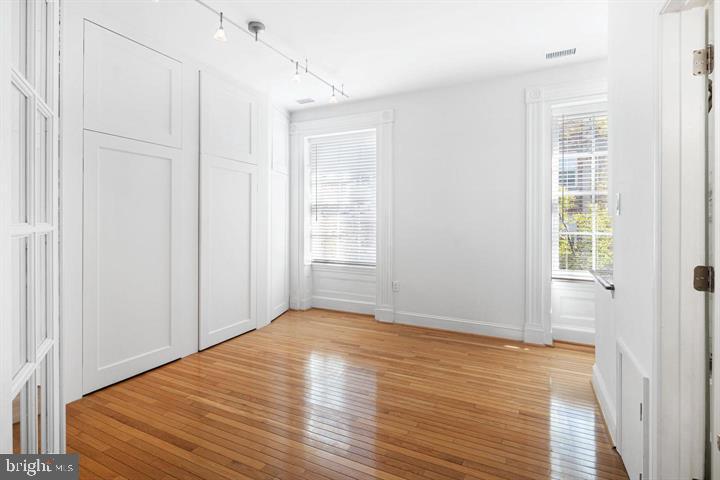 306 South 10th Street, Unit D Philadelphia, PA 19107 - Photo 22 of 35 a view of an empty room with wooden floor and a window