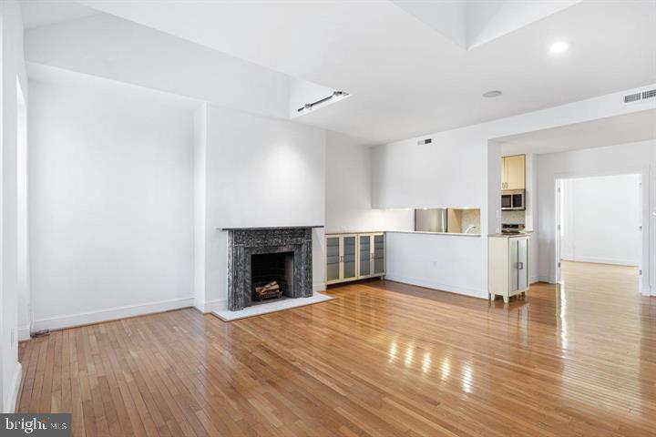 306 South 10th Street, Unit D Philadelphia, PA 19107 - Photo 6 of 35 a view of empty room with wooden floor and fireplace