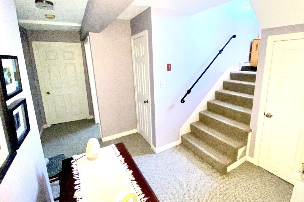 110 Carolyn Road Weymouth, MA 02190 - Photo 13 of 18 a view of a bedroom with wooden floor and stairs
