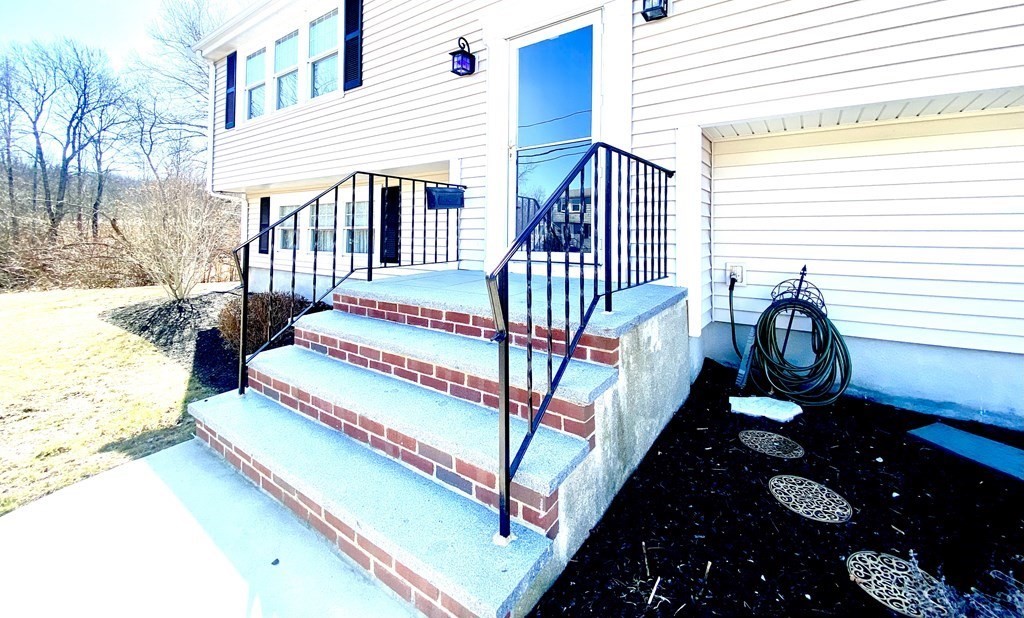 110 Carolyn Road Weymouth, MA 02190 - Photo 17 of 18 a front view of a house with balcony and wooden stairs