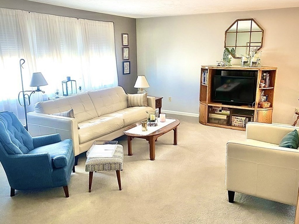 110 Carolyn Road Weymouth, MA 02190 - Photo 2 of 18 a living room with furniture and a flat screen tv