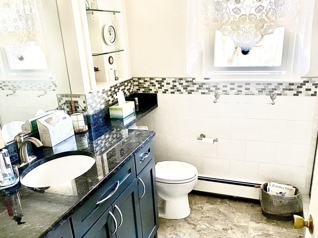 110 Carolyn Road Weymouth, MA 02190 - Photo 6 of 18 a bathroom with a sink mirror and toilet