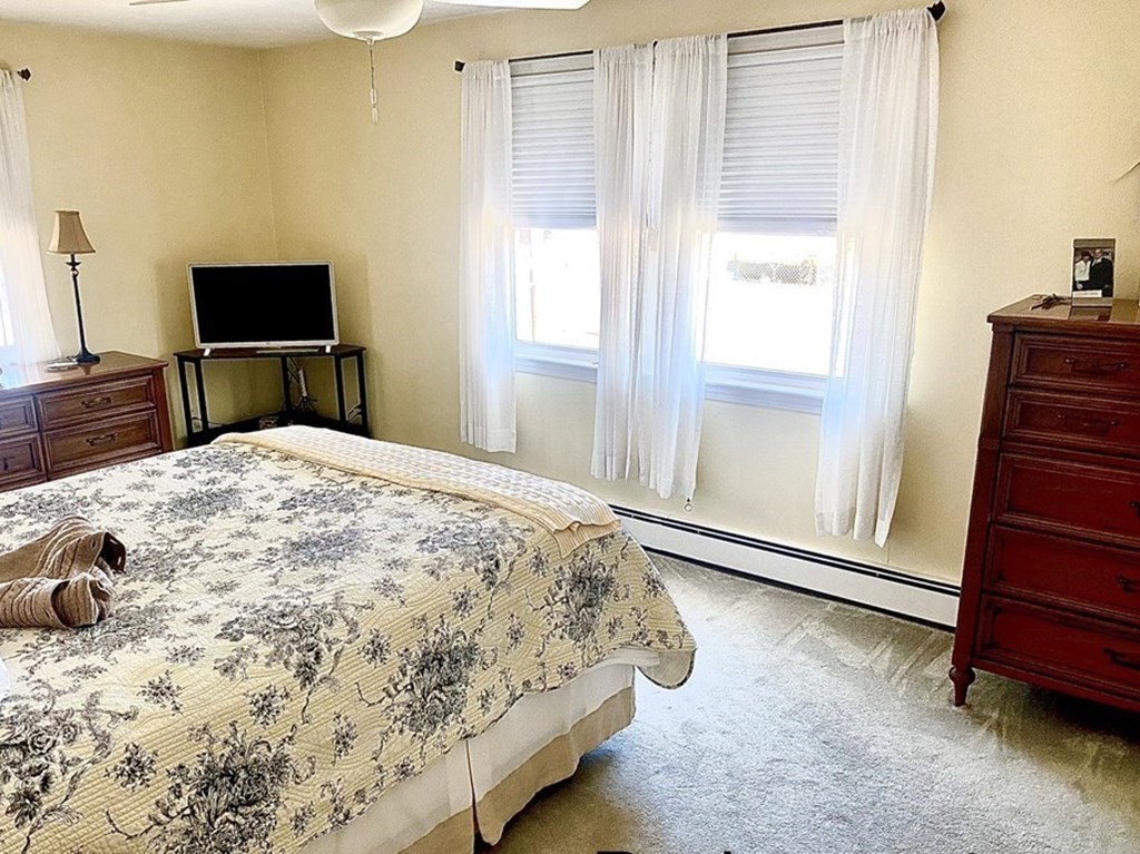 110 Carolyn Road Weymouth, MA 02190 - Photo 7 of 18 a bedroom with a bed and a flat tv screen on top of a dresser