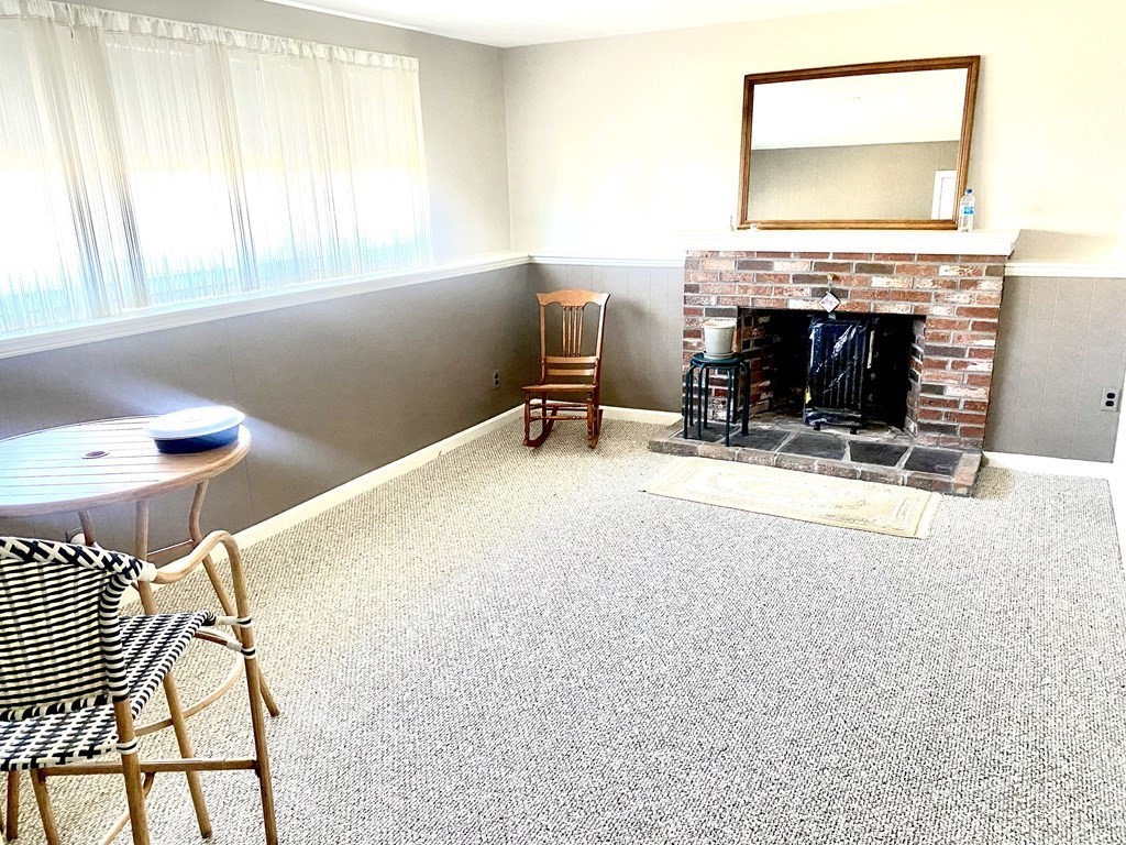 110 Carolyn Road Weymouth, MA 02190 - Photo 9 of 18 a living room with furniture and a fireplace