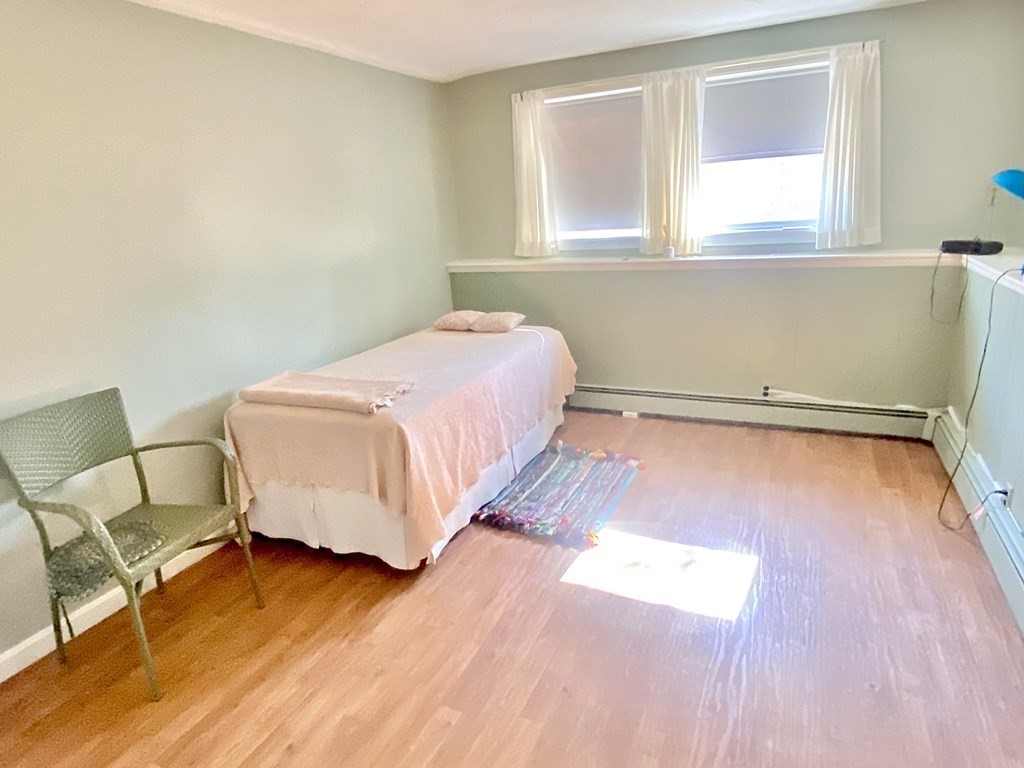 110 Carolyn Road Weymouth, MA 02190 - Photo 10 of 18 a bedroom with a bed and wooden floor