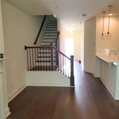 a view of an empty room with wooden floor