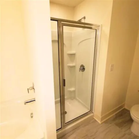 a bathroom with a glass shower door