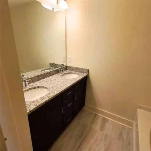 a bathroom with a granite countertop sink and a granite