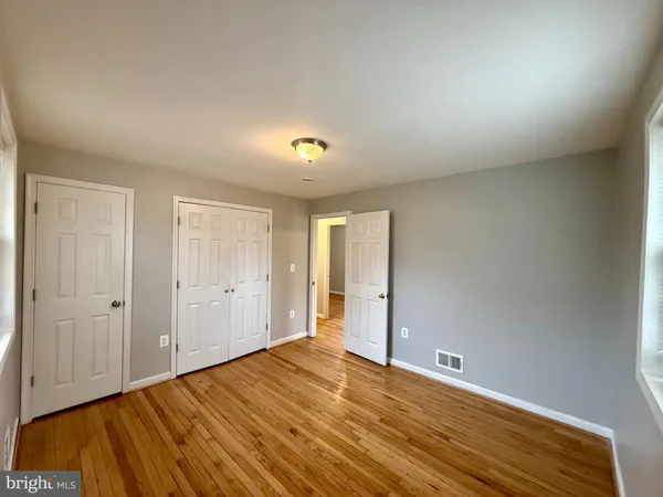 a view of an empty room and wooden floor