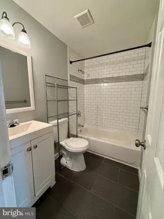 a bathroom with a toilet sink and shower