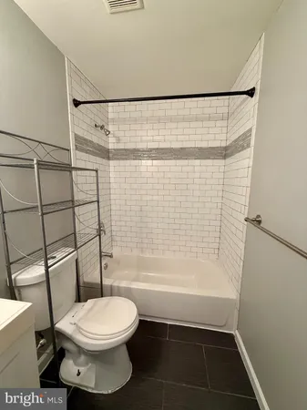 a bathroom with a toilet and shower