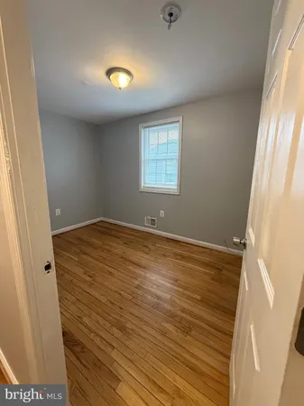a view of room with window and hardwood floor