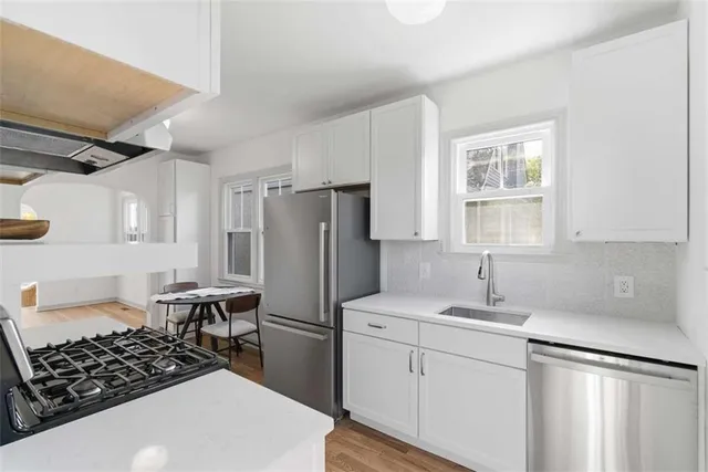 a kitchen with a sink appliances and cabinets