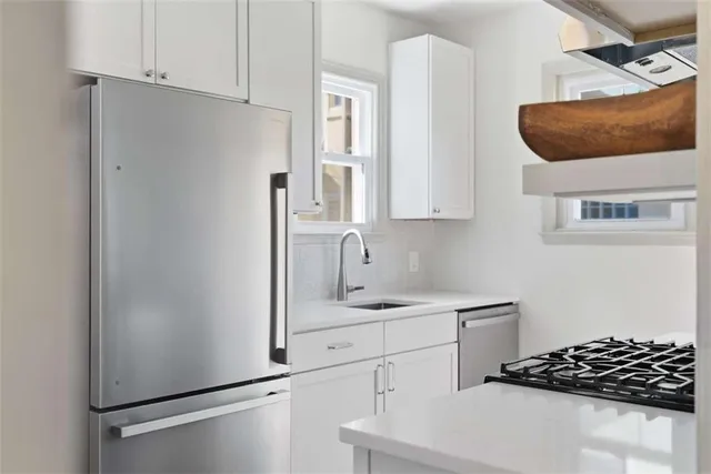 a kitchen with stainless steel appliances a refrigerator and a sink