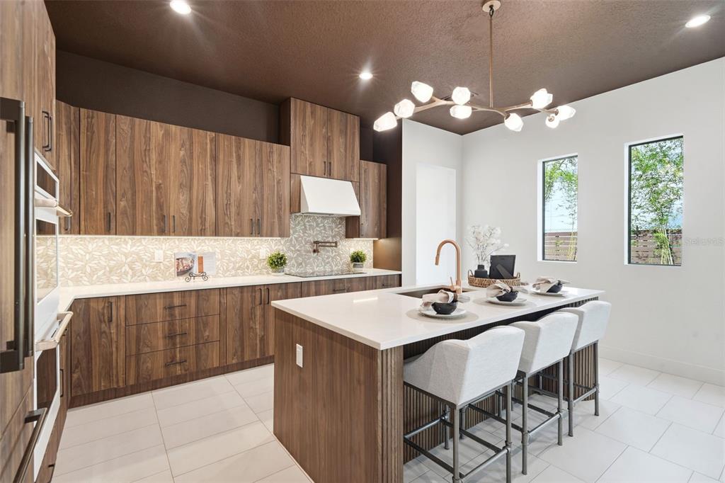 1615 Cole Road Orlando, FL 32803 - Photo 10 of 31 a kitchen with a table chairs and white cabinets