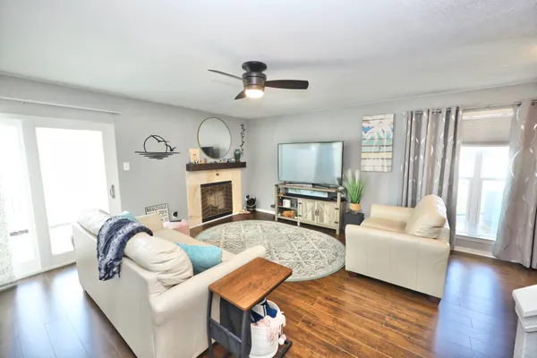 a living room with furniture and wooden floor