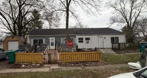 a view of a house with a yard and tree s