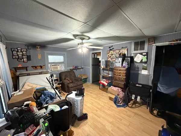 a living room with furniture a flat screen tv and gym equipment