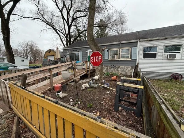 a view of a street with wooden fence