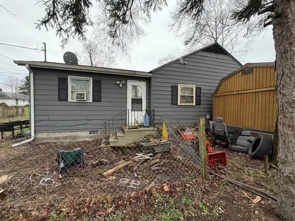 a view of a house with a yard and a tree