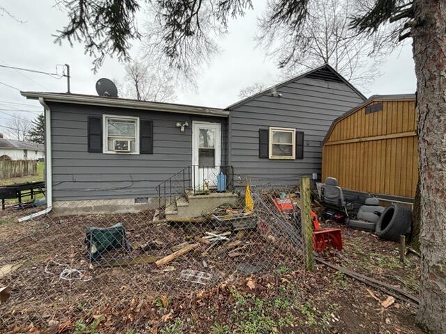 259 South Ivanhoe Road Kingsford Heights, IN 46346 - Photo 7 of 22 a view of a house with a yard and a tree
