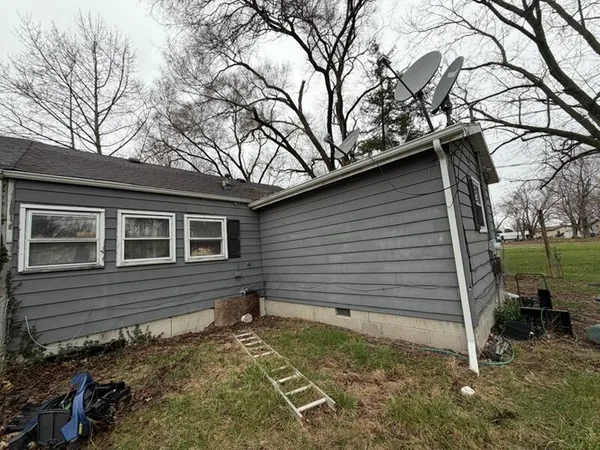 a side view of a house with a yard