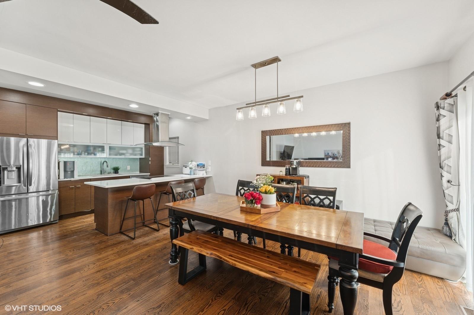 Dining area with recessed lighting and dark wood-style flooring