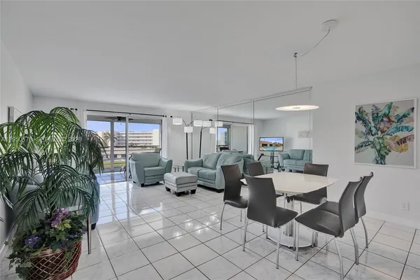 a living room with furniture potted plant and a window