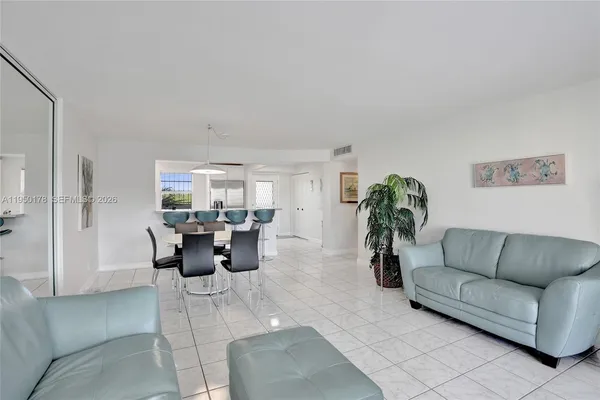 a living room with furniture and large windows