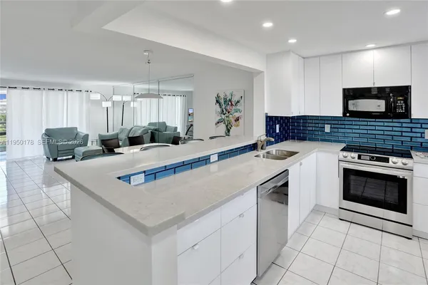 a kitchen with stainless steel appliances granite countertop a sink and a stove