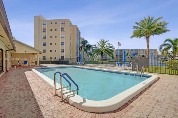 a view of swimming pool with outdoor seating