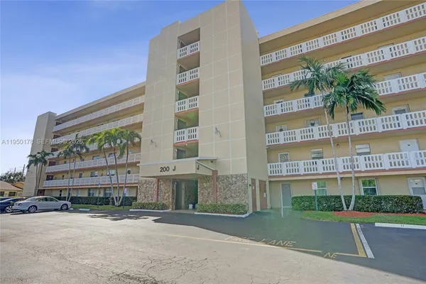 a view of a tall building next to a yard