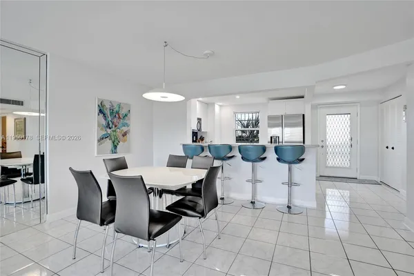 a living room with furniture a dining table and chairs