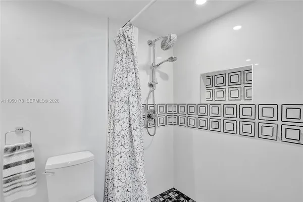 a bathroom with a bathtub and a shower
