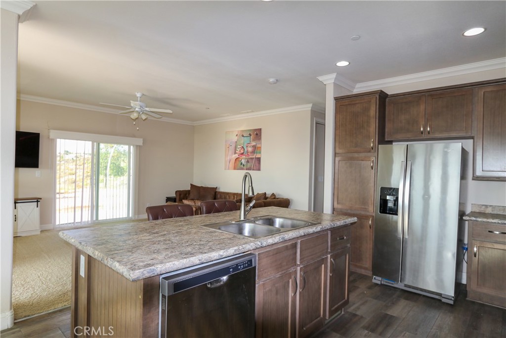 24000 Oak Cir Drive Wildomar, CA 92595 - Photo 11 of 22 a kitchen with stainless steel appliances granite countertop a kitchen island a refrigerator and a sink