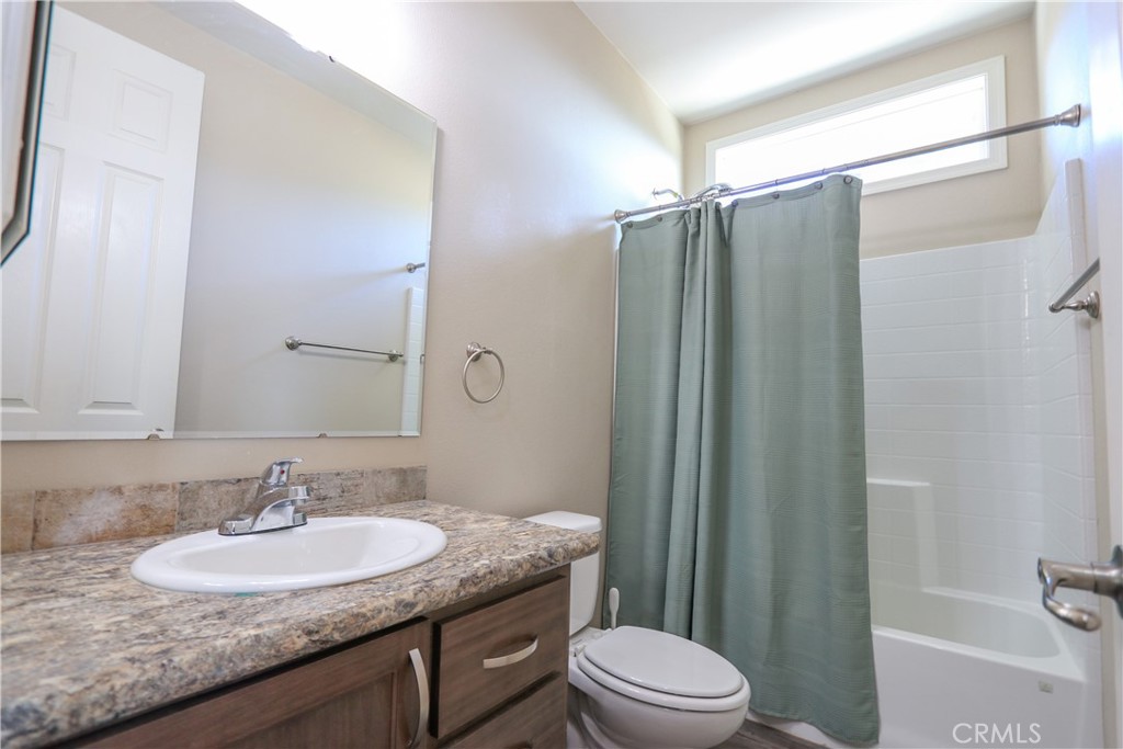 24000 Oak Cir Drive Wildomar, CA 92595 - Photo 13 of 22 a bathroom with a granite countertop sink toilet and shower