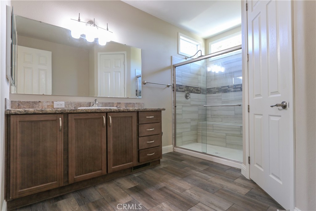 24000 Oak Cir Drive Wildomar, CA 92595 - Photo 16 of 22 a bathroom with a granite countertop sink toilet and shower