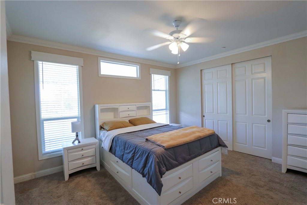 24000 Oak Cir Drive Wildomar, CA 92595 - Photo 17 of 22 a bedroom with a bed and a chandelier