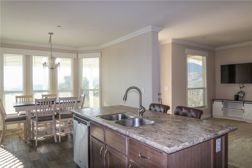 24000 Oak Cir Drive Wildomar, CA 92595 - Photo 10 of 22 a kitchen with a stove a sink a dining table and chairs