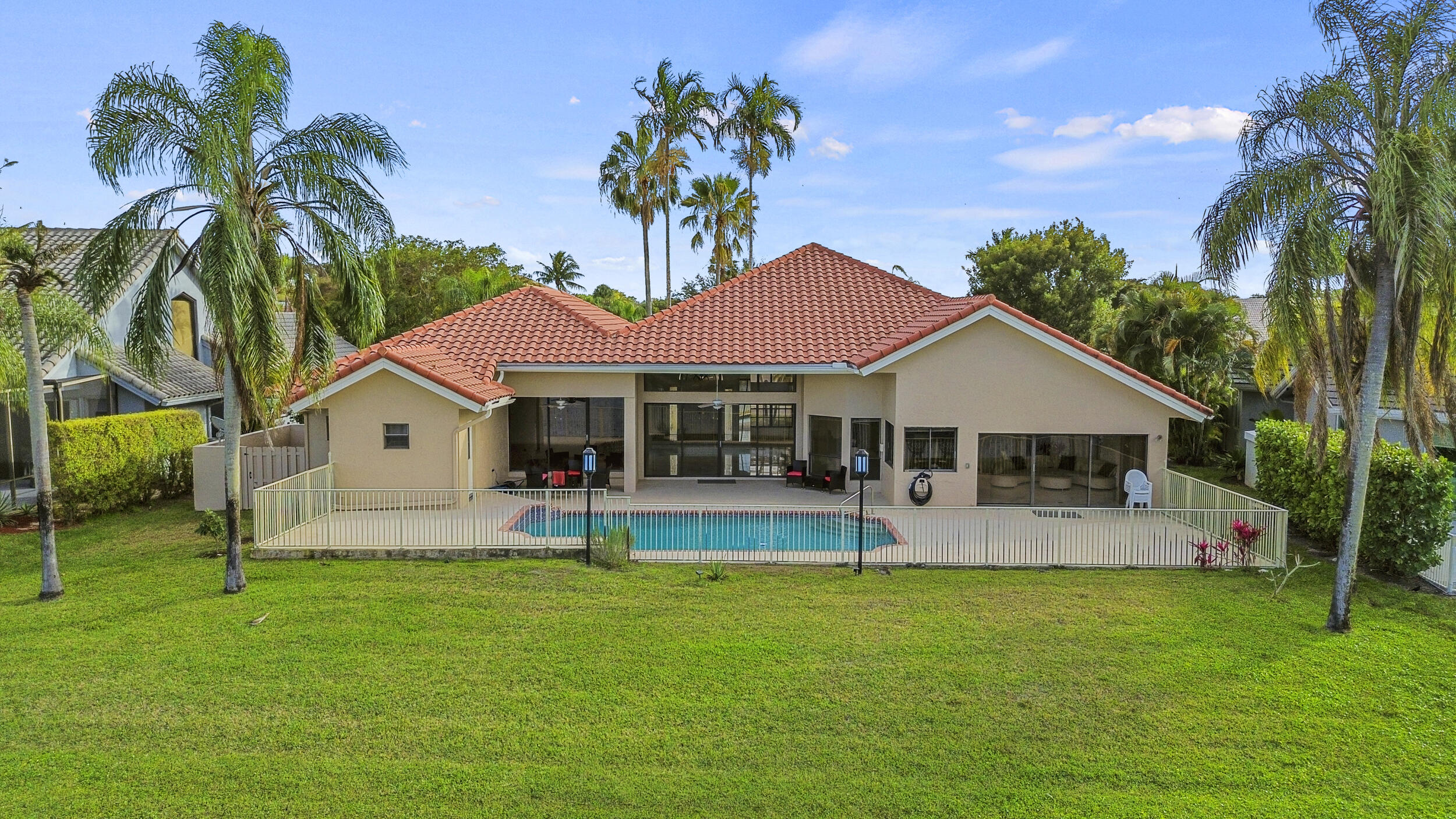 10747 Stonebridge Boulevard Boca Raton, FL 33498 - Photo 62 of 75 a view of house with swimming pool and green space