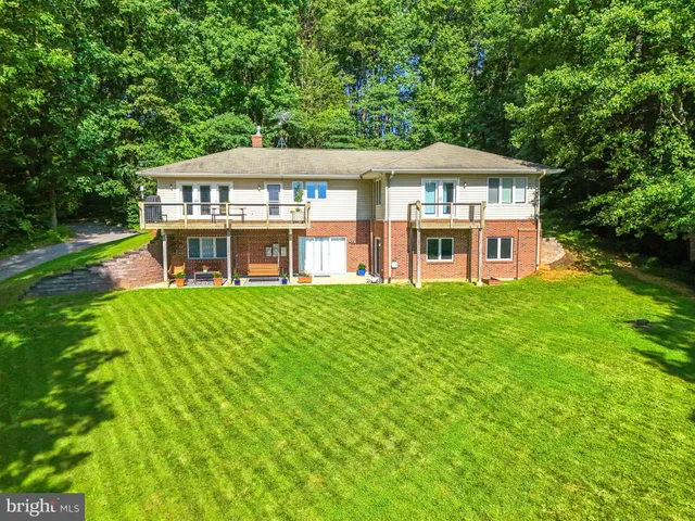 a view of a house with a backyard porch and sitting area