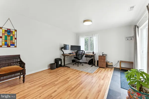 a bedroom with a bed and wooden floor