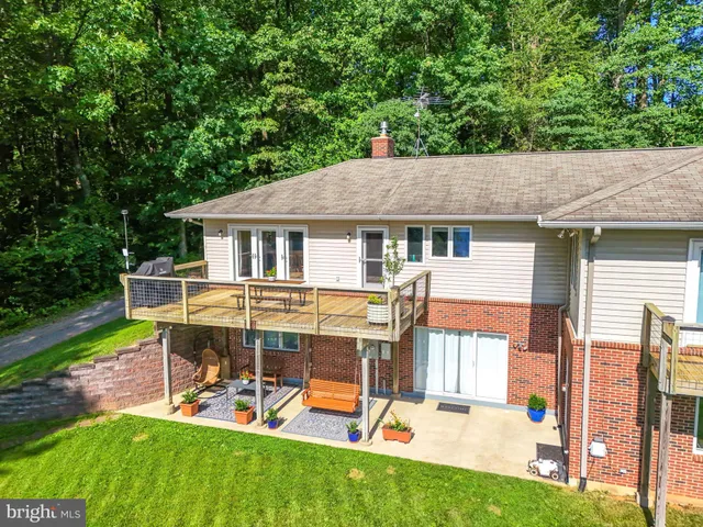 a living room with furniture wooden floor and a large window