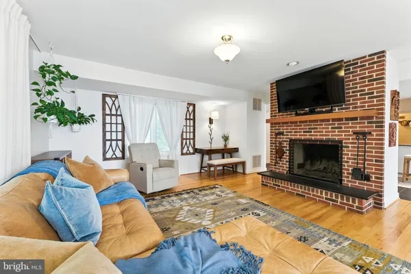 a living room with fireplace furniture and a flat screen tv