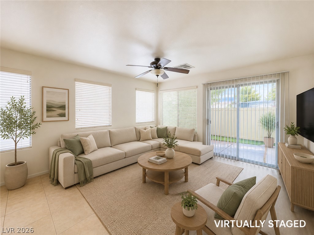 9456 Grandview Spring Avenue Las Vegas, NV 89166 - Photo 10 of 49 Virtually Staged. A well-lit living area offers comfort and direct access to an outdoor patio.