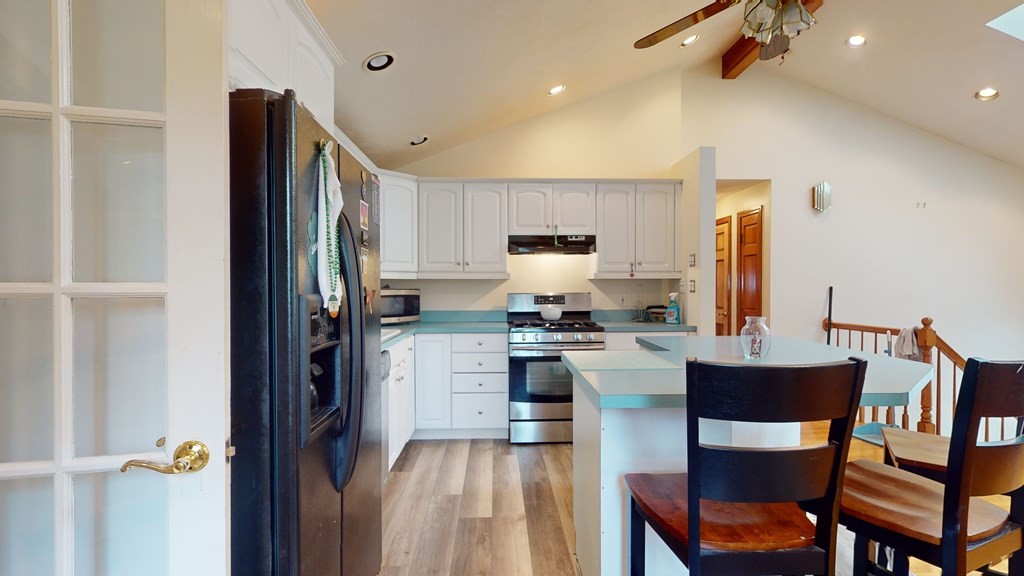 8 Fernwood Road Billerica, MA 01821 - Photo 7 of 23 a kitchen with a table chairs refrigerator and microwave