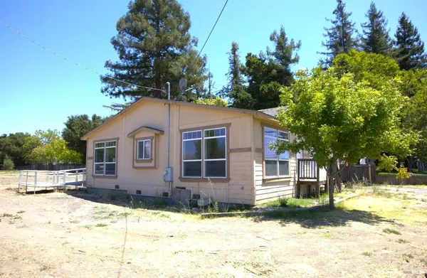 a backyard of a house with a yard and garage