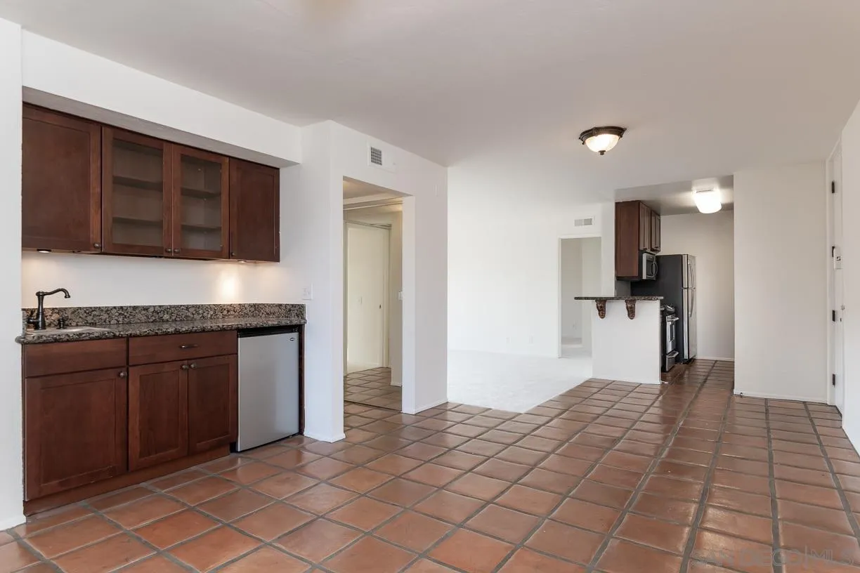 6314 Friars Road, Unit 301 San Diego, CA 92108 - Photo 12 of 31 a kitchen with a refrigerator and a stove top oven