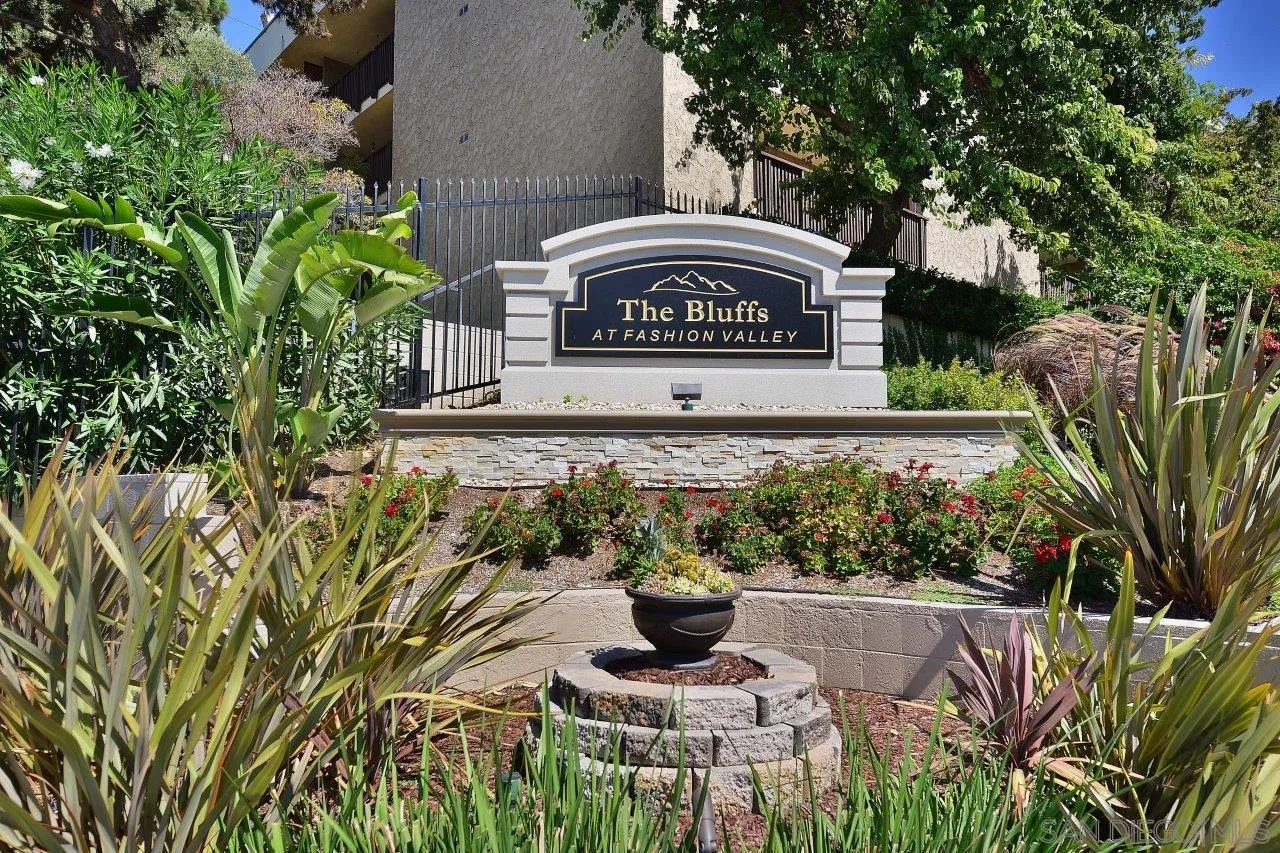 6314 Friars Road, Unit 301 San Diego, CA 92108 - Photo 19 of 31 a view of a sign in a yard with potted plants and tree