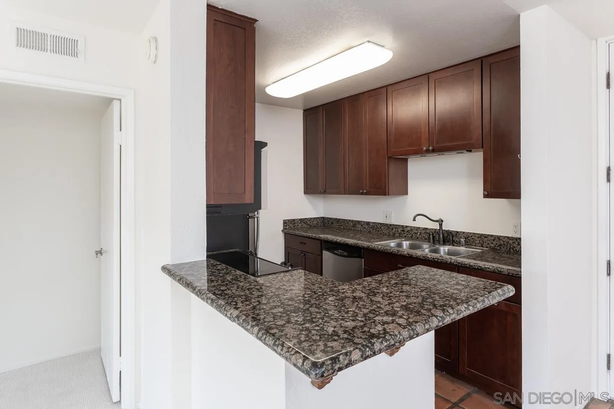 6314 Friars Road, Unit 301 San Diego, CA 92108 - Photo 6 of 31 a kitchen with a sink a counter top space and cabinets
